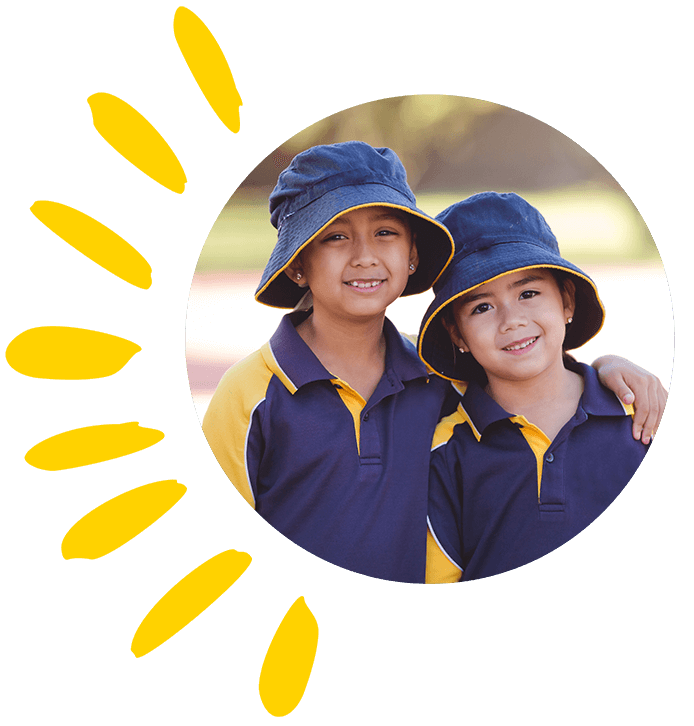 Two primary school students stand arm in arm with sun safe hats and uniforms.