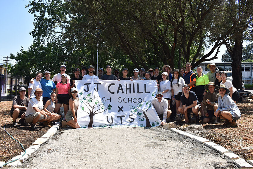 Students hold a banner reading "J J Cahill High School x UTS"
